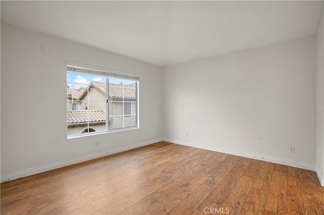 spare room with hardwood / wood-style flooring