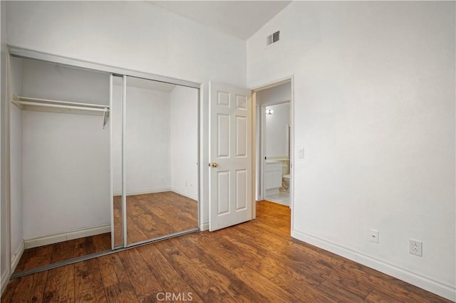 unfurnished bedroom with hardwood / wood-style floors and a closet