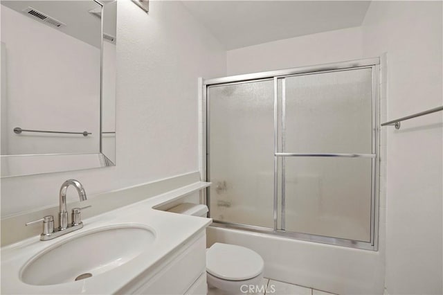 full bathroom with vanity, shower / bath combination with glass door, and toilet