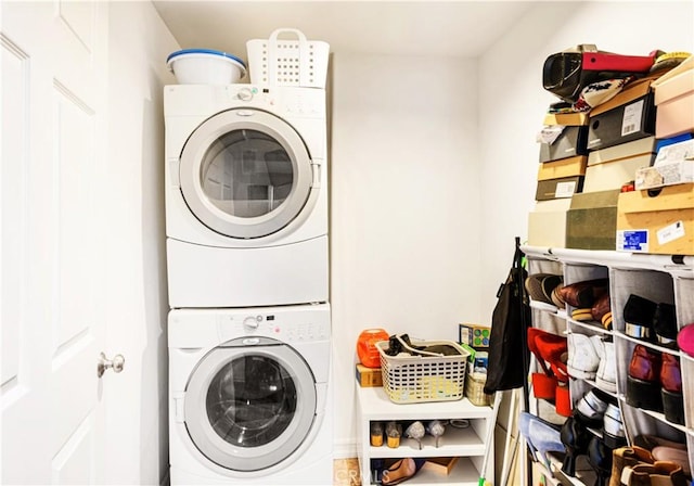 washroom featuring stacked washer and clothes dryer