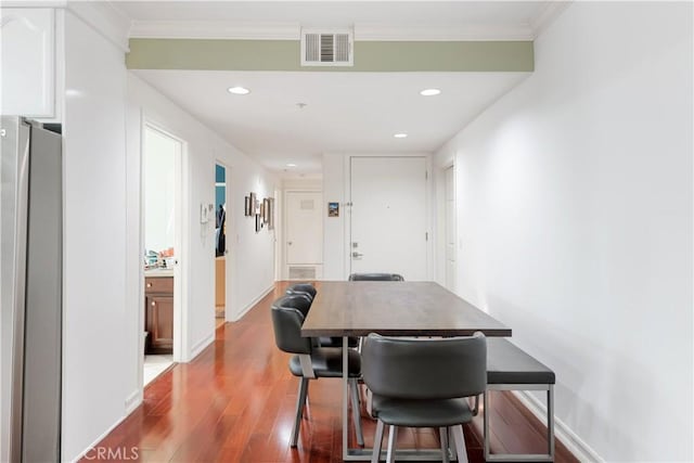 dining room featuring crown molding and hardwood / wood-style flooring