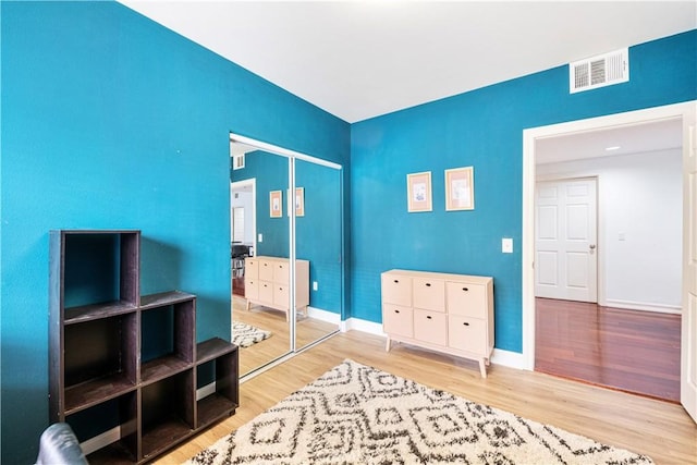 bedroom featuring light wood-type flooring and a closet