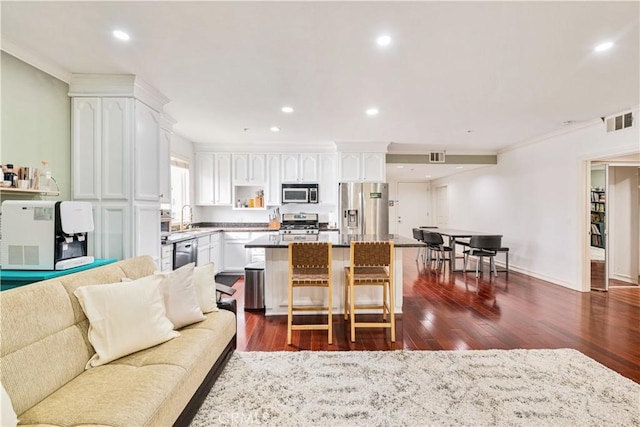 living room featuring crown molding, sink, and dark hardwood / wood-style floors