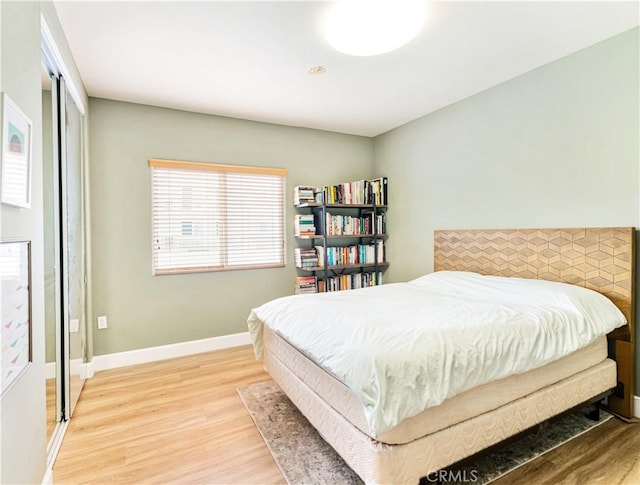 bedroom featuring light hardwood / wood-style floors and a closet