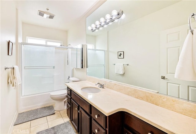 full bathroom with toilet, tile patterned floors, bath / shower combo with glass door, and vanity