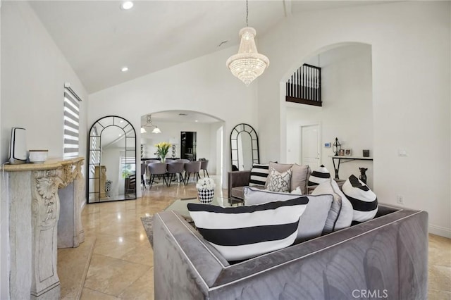 living room with a chandelier and high vaulted ceiling