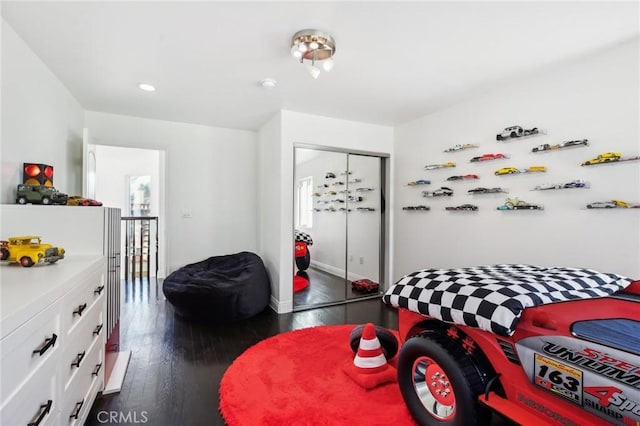 bedroom featuring dark hardwood / wood-style flooring and a closet