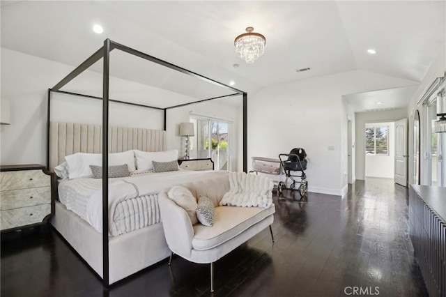 bedroom with multiple windows, dark wood-type flooring, vaulted ceiling, and a chandelier