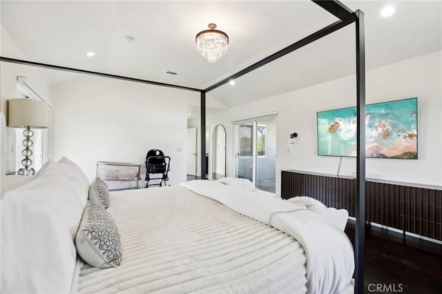 bedroom with lofted ceiling, a notable chandelier, hardwood / wood-style flooring, and access to outside