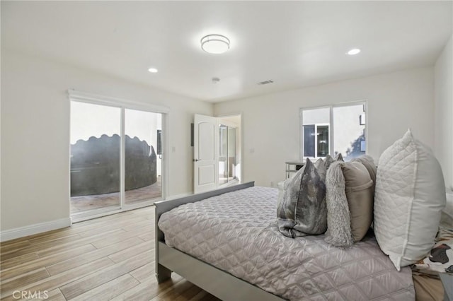 bedroom with light hardwood / wood-style floors and access to outside