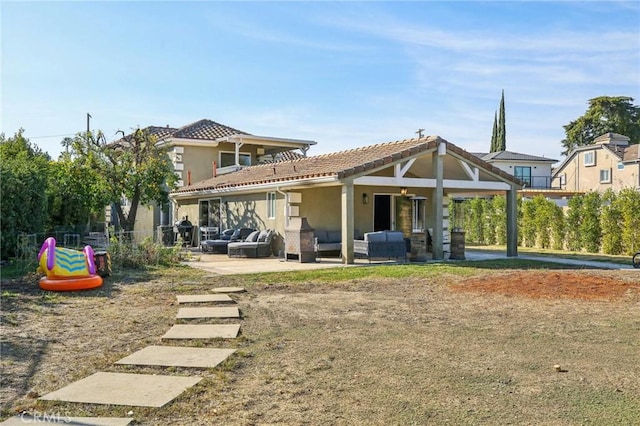 back of house featuring ceiling fan, an outdoor hangout area, and a patio area