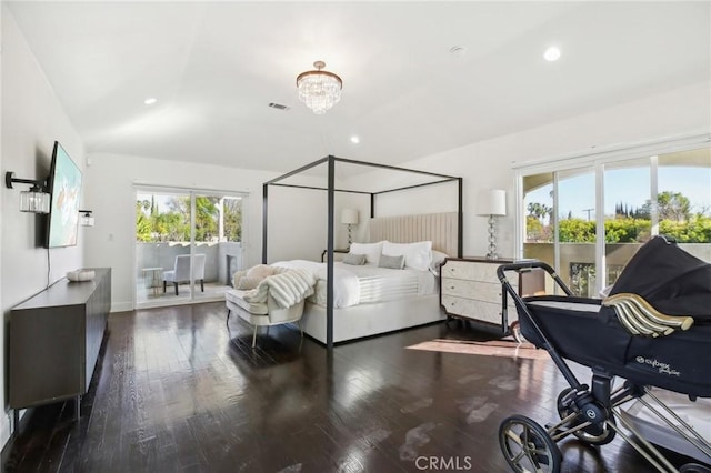 bedroom with dark hardwood / wood-style flooring, a chandelier, vaulted ceiling, and multiple windows