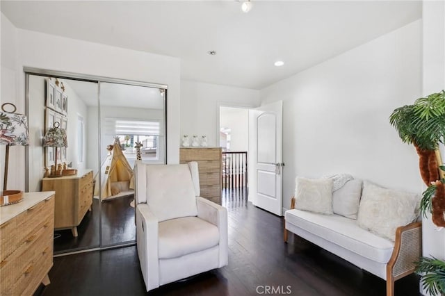 sitting room with dark hardwood / wood-style flooring