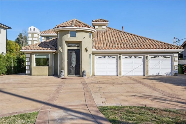 mediterranean / spanish-style home with a garage