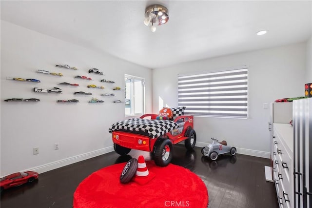 bedroom with dark hardwood / wood-style flooring