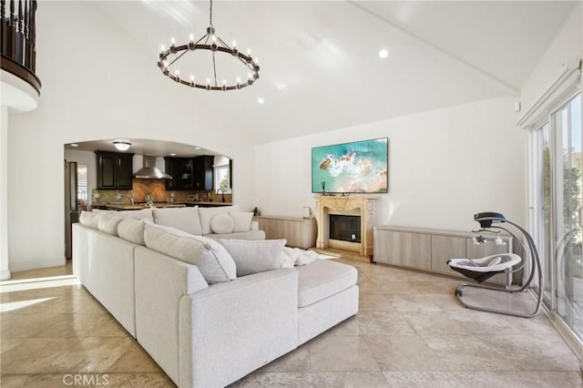 living room with a chandelier and high vaulted ceiling