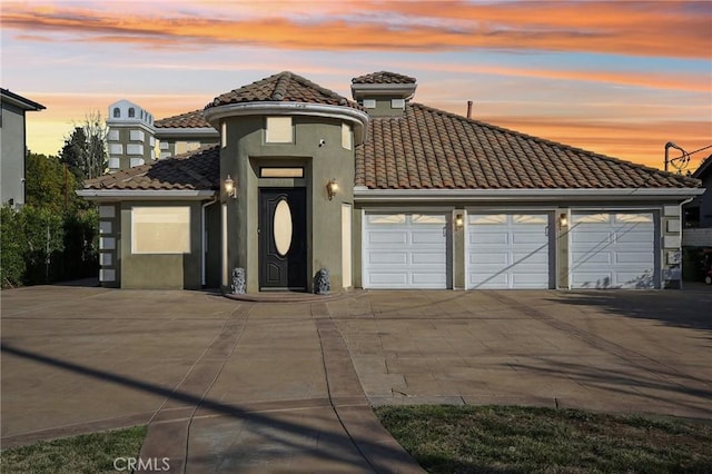 mediterranean / spanish-style home with a garage