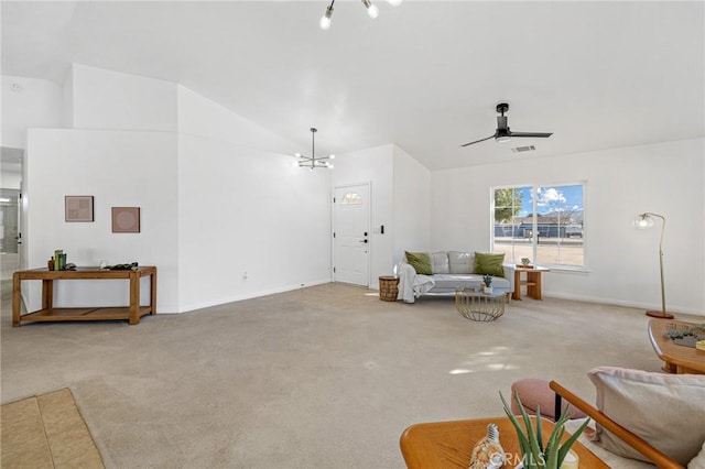 carpeted living room featuring ceiling fan with notable chandelier