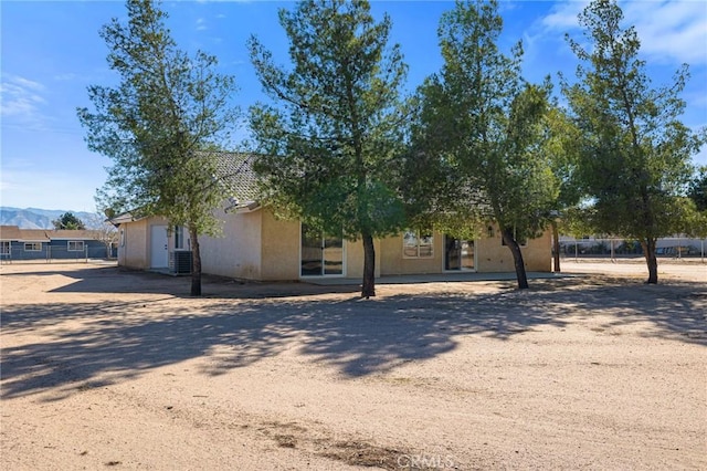 view of property hidden behind natural elements featuring a mountain view