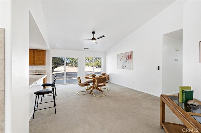 carpeted dining area featuring lofted ceiling and ceiling fan