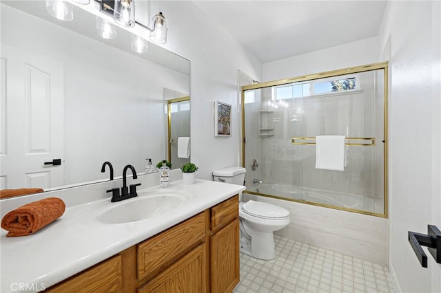 full bathroom with enclosed tub / shower combo, vanity, and toilet