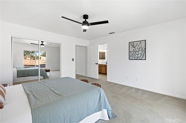 bedroom featuring access to outside, light colored carpet, ceiling fan, and ensuite bathroom