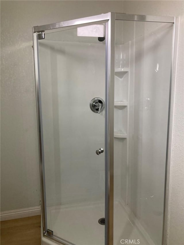 21483 Main St, Barstow, CA 92311 - bathroom with a shower with door and hardwood / wood-style floors