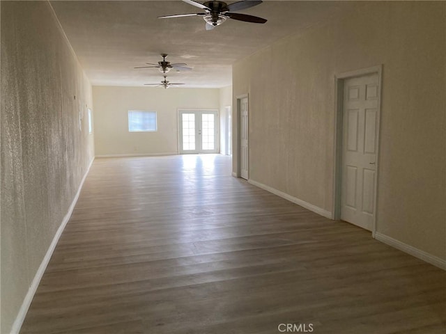 21483 Main St, Barstow, CA 92311 - empty room featuring french doors, ceiling fan, and dark hardwood / wood-style floors