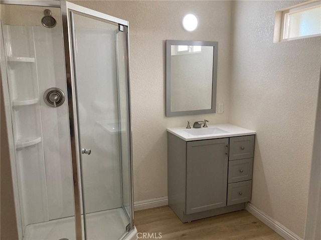 21483 Main St, Barstow, CA 92311 - bathroom with vanity, wood-type flooring, and a shower with door