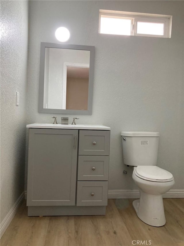 21483 Main St, Barstow, CA 92311 - bathroom with vanity, toilet, and hardwood / wood-style floors