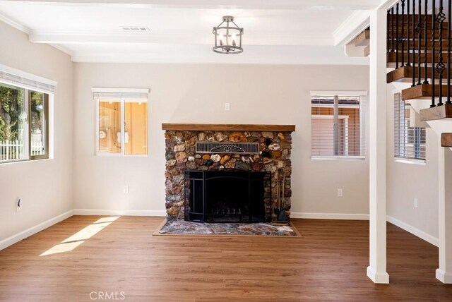 unfurnished living room featuring crown molding, a fireplace, and hardwood / wood-style floors