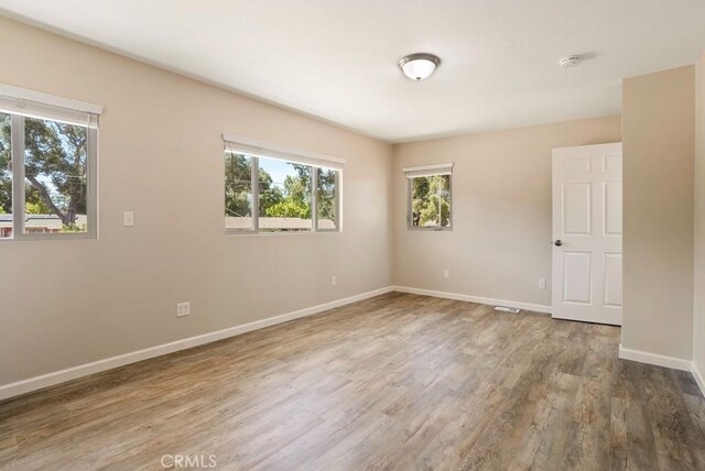 spare room featuring hardwood / wood-style floors