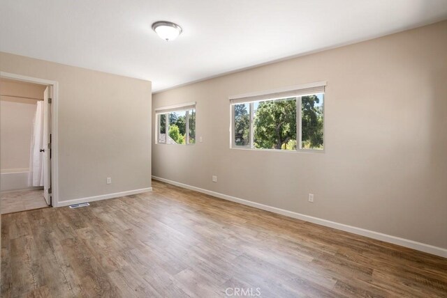 empty room featuring wood-type flooring