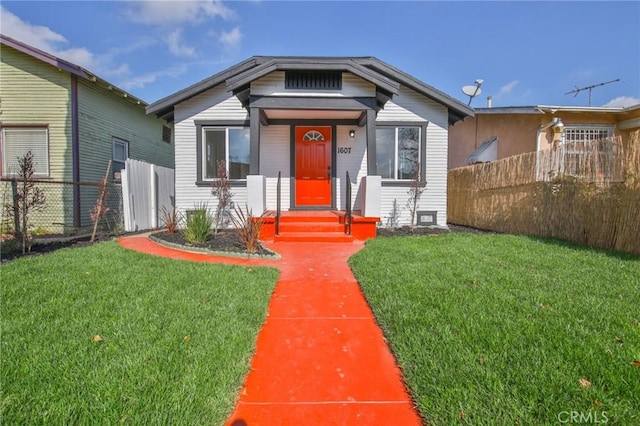 bungalow-style house with a front lawn