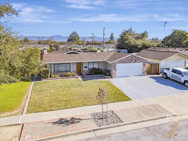 ranch-style home featuring a garage and a front yard