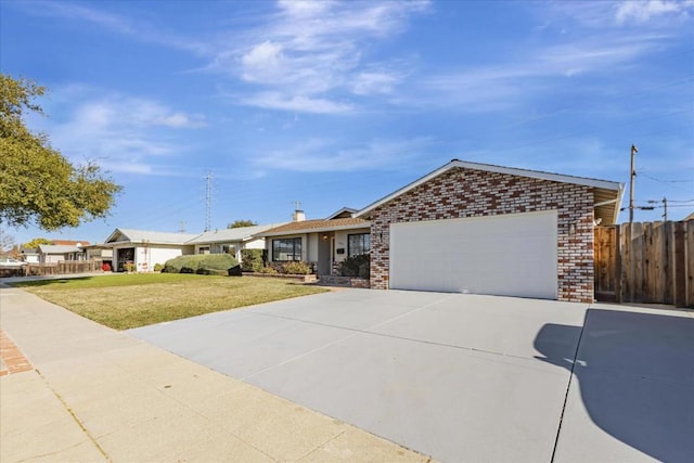 ranch-style home with a garage and a front lawn