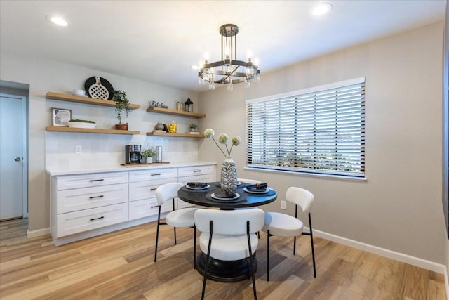 dining space with an inviting chandelier and light hardwood / wood-style floors