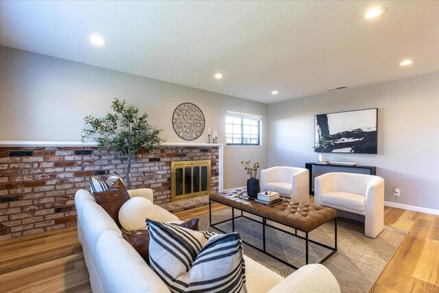 living room featuring a fireplace and light hardwood / wood-style flooring