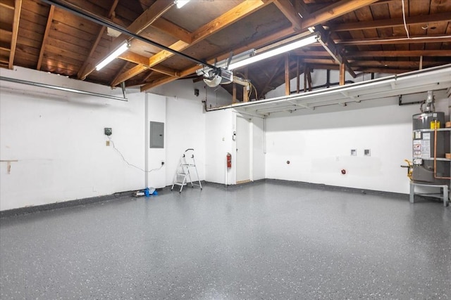 garage with strapped water heater, a garage door opener, and electric panel