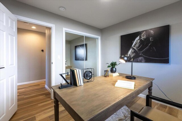 home office with hardwood / wood-style flooring