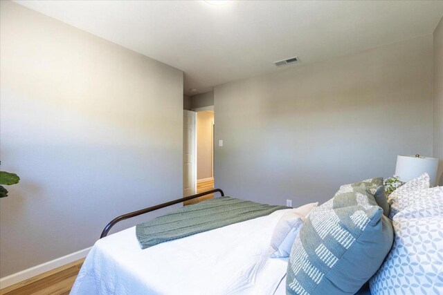 bedroom with hardwood / wood-style floors