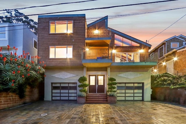 contemporary house with a garage and a balcony