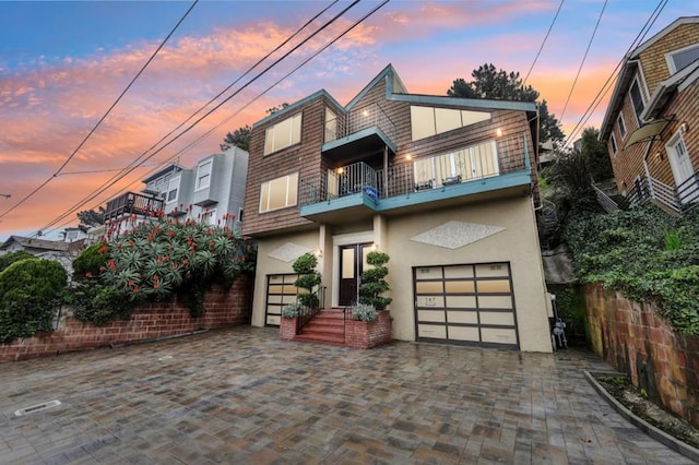 modern home featuring a balcony and a garage