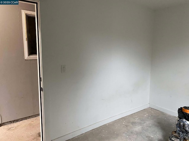 spare room with concrete floors