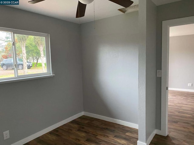 empty room with dark wood-type flooring and ceiling fan