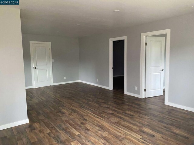 empty room featuring dark wood-type flooring