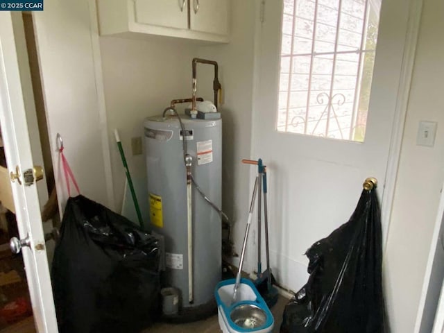 utility room featuring water heater