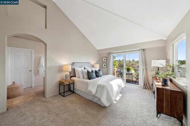 bedroom featuring light colored carpet, access to exterior, and high vaulted ceiling