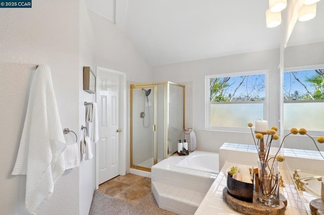 bathroom featuring independent shower and bath and vaulted ceiling