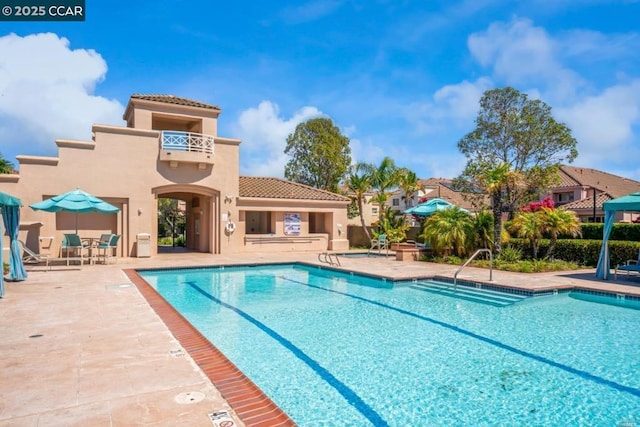 view of swimming pool with a patio area